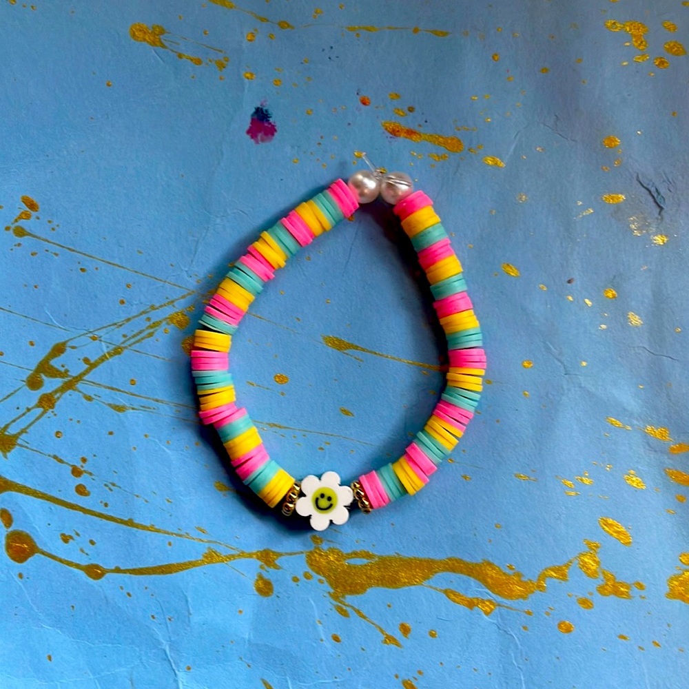 This is a yellow blue and pink with a flower on in the middle fits 8-13 years